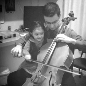 My little daughter helping me to play the cello